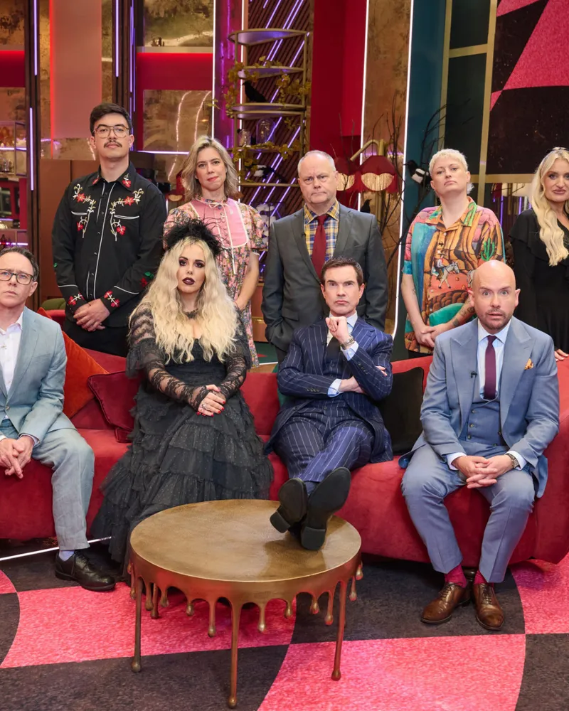 Cast group photo on a red sofa