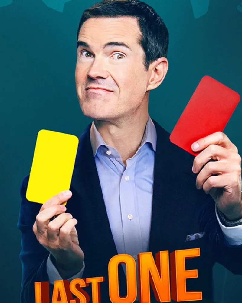 Jimmy Carr holding up yellow and red cards